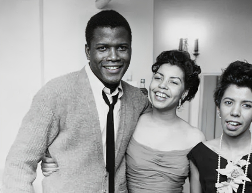 Juanita Hardy posing with her husband, Sidney Poitier inside a room as they are both smiling. 